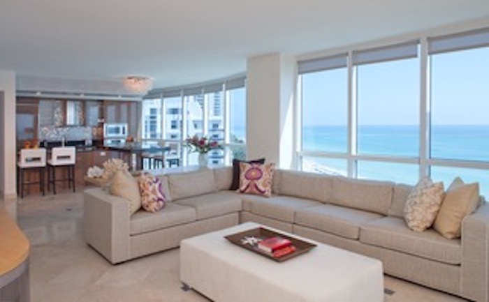 Custom sectional and coffee table / ottoman with Lucite feet by Kevin Gray